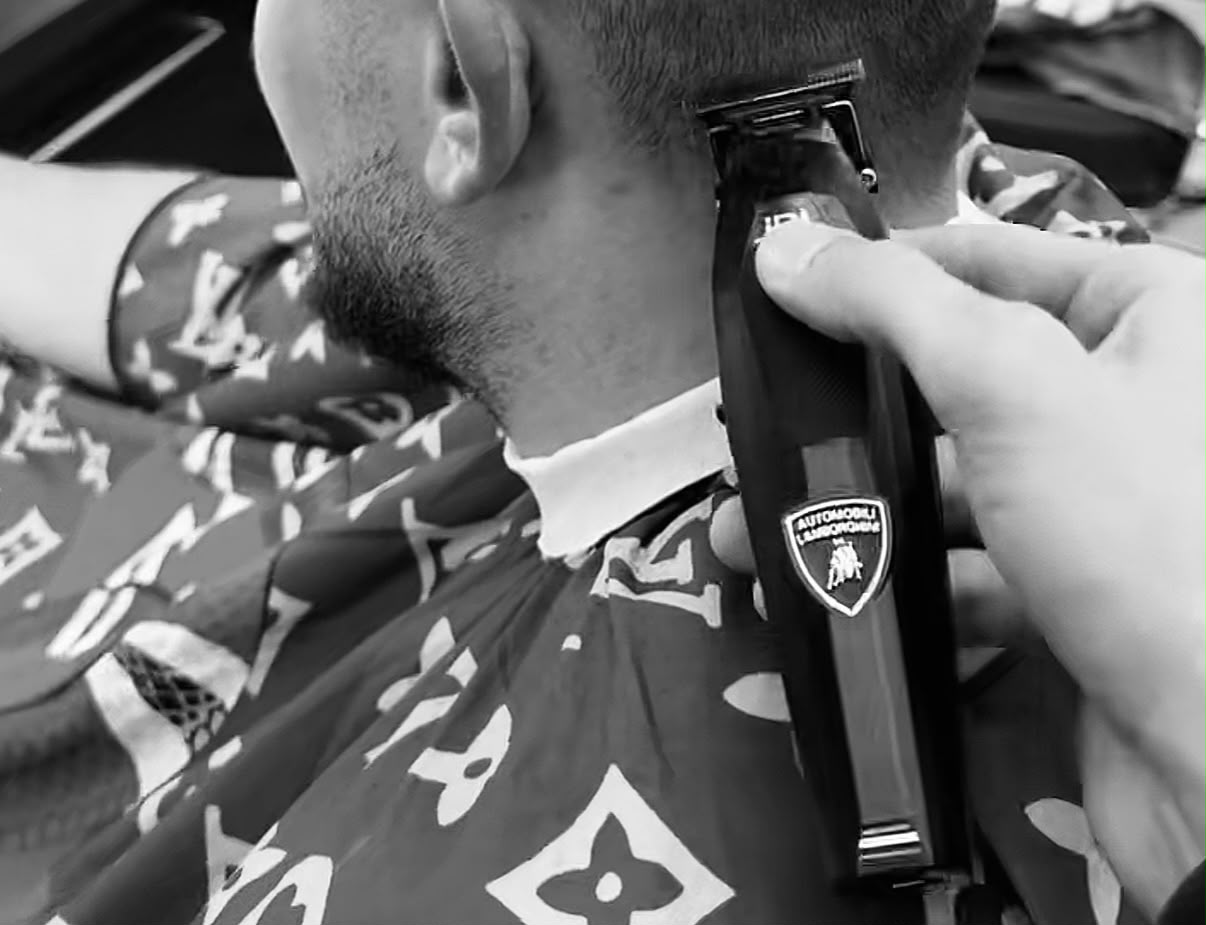 Downtown Trim barber shaping a client's fade with clippers